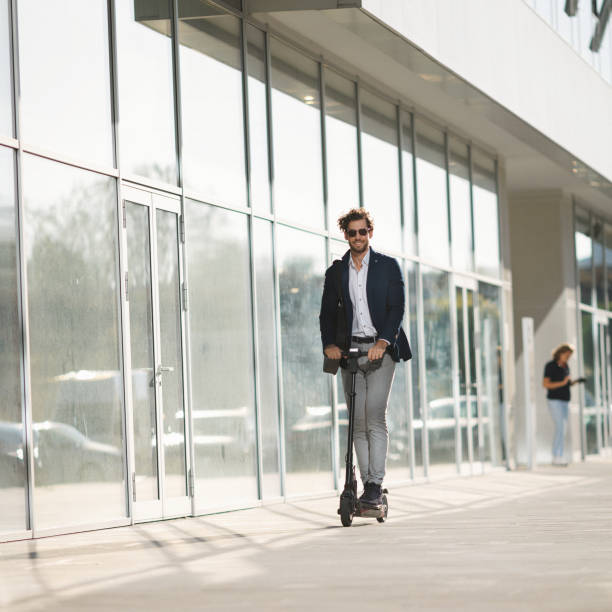 istock Young businessman driving e-scooter in the city 1216231675
