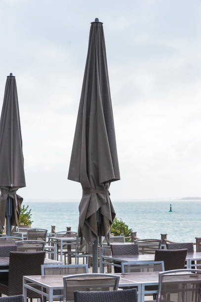 istock Empty restaurant with umbrella in front of the sea 1216232719
