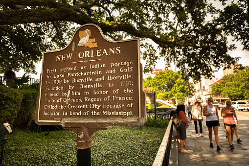 New Orleans, Louisiana - June 17, 2019:  Historic information road marker along the sidewalk by Jackson Square in New Orleans Louisiana USA.  Originally named the Crescent City because of it's location on the bend of the Mississippi