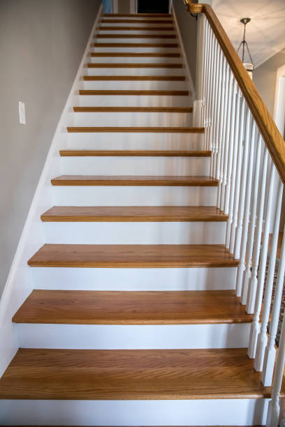 istock light-colored and white painted hardwood stairs stairway in a modern updated new construction home with a white banister 1216233012