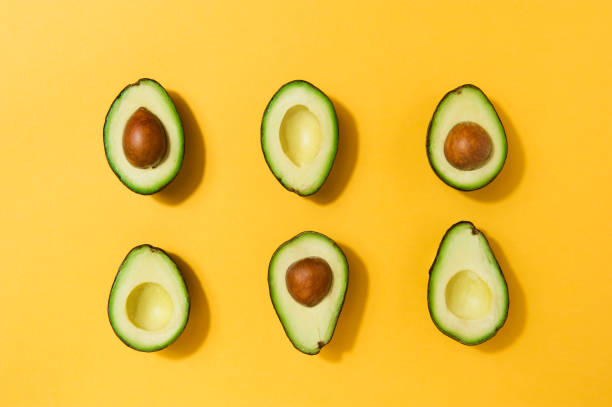 istock Fresh avocados arranged on a yellow background 1216233483