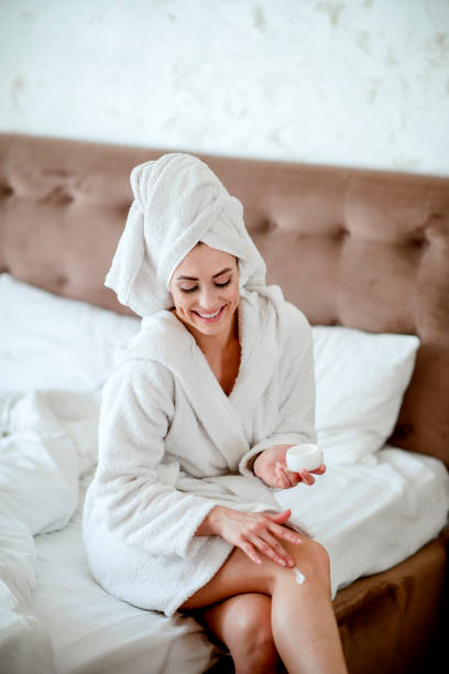 istock Woman Applying Moisturizer To Her Legs 1216233542