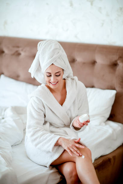 istock Woman Applying Moisturizer To Her Legs 1216234602
