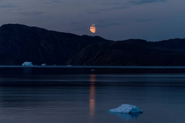 Landscape with beautiful pink icebergs hit by the setting sun in Disko Bay in Ilulissat, Greenland