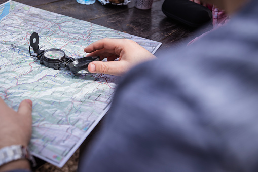 Latin tourist consulting the street map in the Gothic Quarter of Barcelona (Spain), selective approach to the left hand side, travel concept.