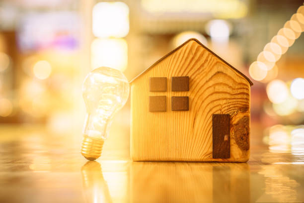 istock Wood house with Light bulb on the table, a symbol for construction, Creative light bulb idea, power energy or business idea concept ecology, loan, mortgage, property or home. 1216236866