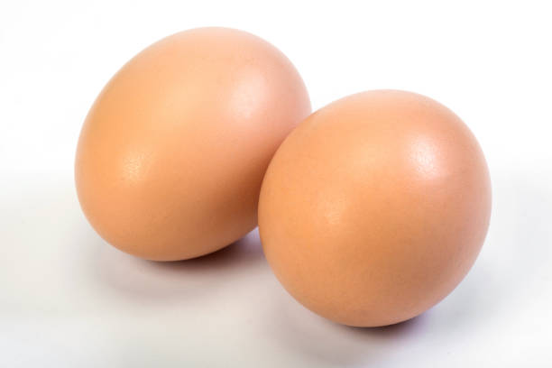 istock Two chicken brown eggs are close on a white background. 1216241150