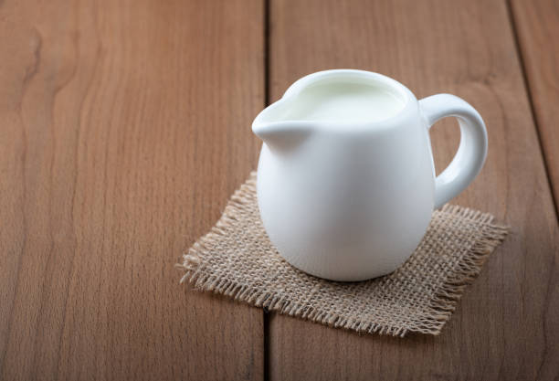 istock White jug with milk on a wooden rustic background 1216241187