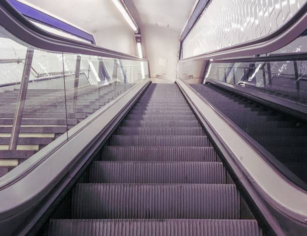A modern escalator in the subway. Photograph taken from below.