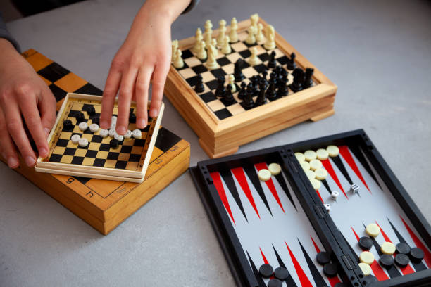 istock Board games on the table. Chess, backgammon, checkers. Boards are laid out for the game. Play, have fun at home. Leisure, hobbies 1216244096