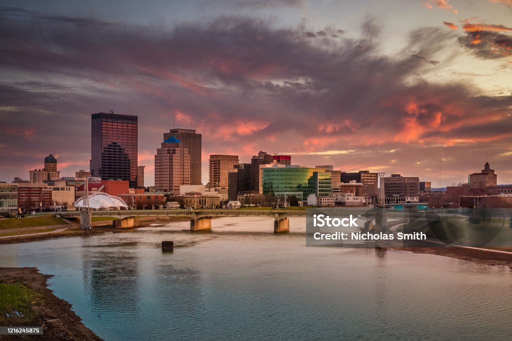 Urban Pink The skyline of downtown Dayton, Ohio under a sunset of pink clouds from the Great Miami River taken from a drone for an aerial view. Dayton - Ohio Stock Photo