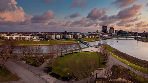 Colorful Urban Waterfront An aerial drone photo in the evening over the waterfront at the confluence of the Great Miami and Mad Rivers in downtown Dayton, Ohio looking toward the city in early spring. dayton ohio skyline stock pictures, royalty-free photos & images