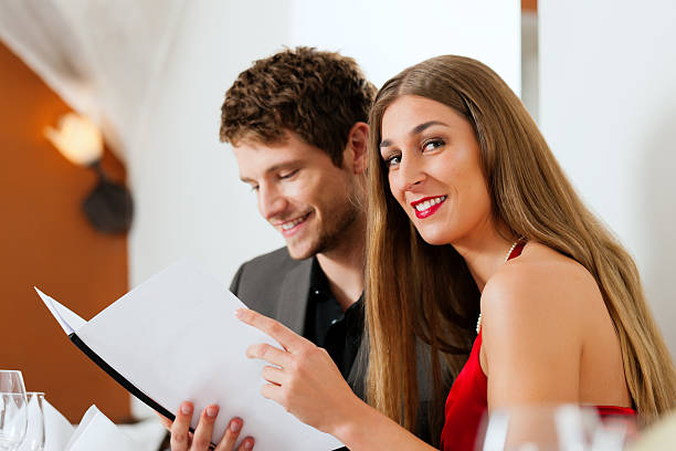 istock Couple looking into menu of restaurant 121624699