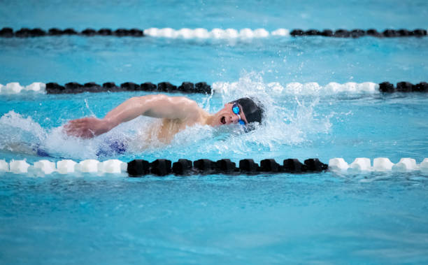 istock Young male swimmer swims freestyle during a competition 1216247313