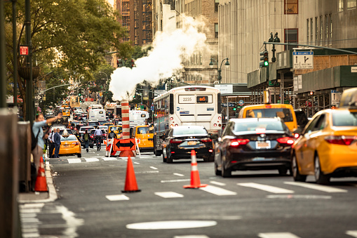 Manhattan, New York - September 19, 2019:  Taxis, bikes and car traffic roll down Broadway at rush hour on the busy streets of downtown Manhattan New York City USA