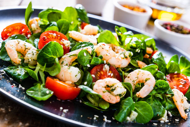 istock Prawns with vegetables on wooden table 1216250465