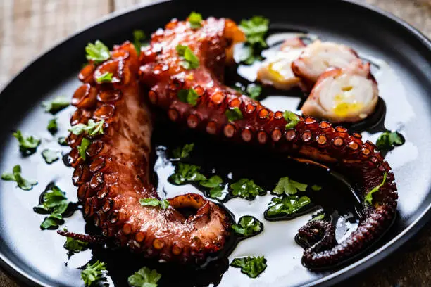 Fried octopus on wooden table
