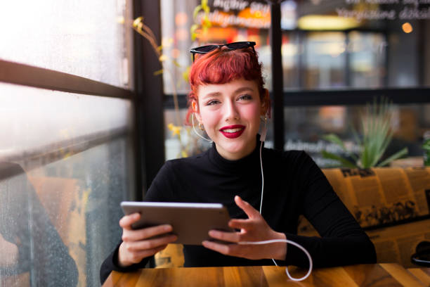 istock pretty young girl is using tablet 1216250980