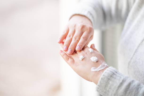 istock Smiley made with hand cream on woman's hands 1216251141