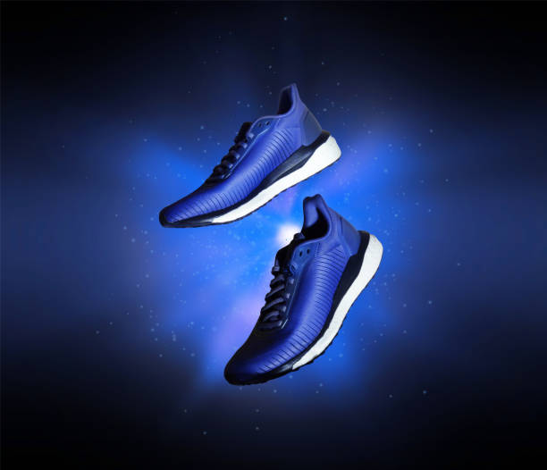 istock Technological running shoes with a flash of blue light in the dark 1216252390