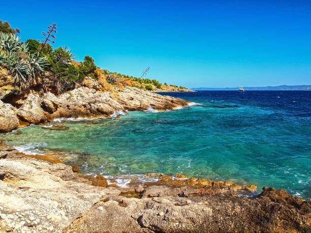 Abstract from beautiful coastline of Brac island, Dalmatia, Croatia. Famous touristic destination. A place of untouched wilderness and paradise turquoise sea. Hvar island in the background.