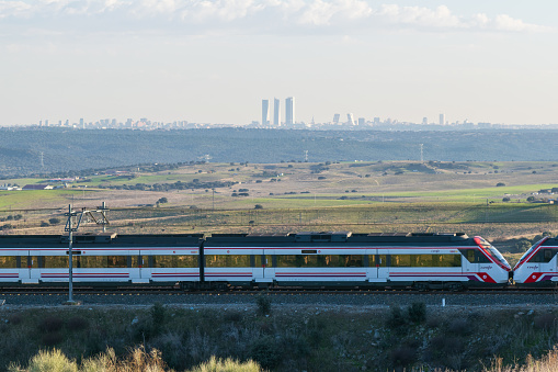 26-12-2018. Madrid,Spain. Madrid commuter train. Landscape with Madrid city skycrapers on the skyline.