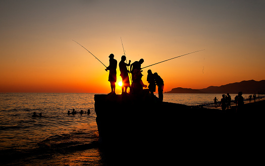 Men fishing on the Antalya. It was taken during sunset.