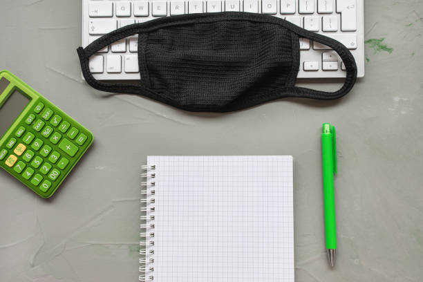 istock Home office background. Mask and notebook on gray 1216256540