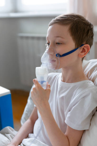 istock Portrait of kid boy using oxygen mask. 1216256720