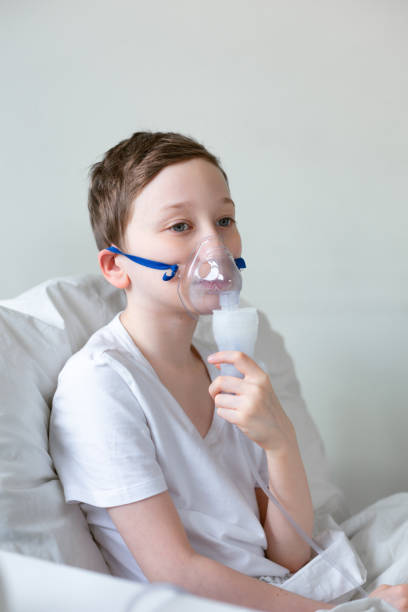 istock Portrait of kid boy using oxygen mask. 1216256738