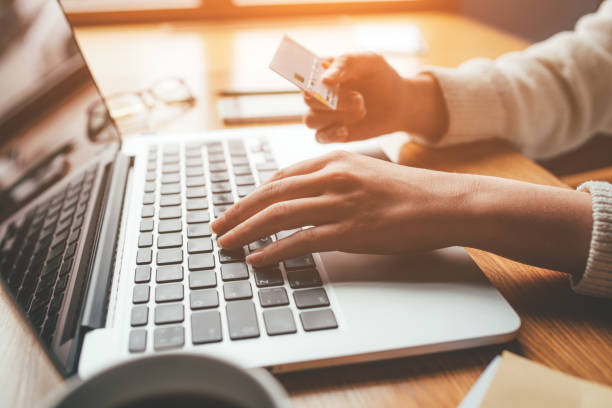 istock A young woman makes an online payment for a purchase. 1216258436
