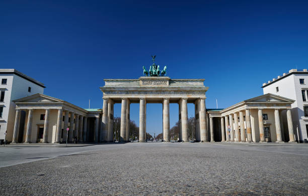 Wide angle of the Brandenburger Gate Deserted Brandenburger Gate during the Corona crisis brandenburg gate photos stock pictures, royalty-free photos & images