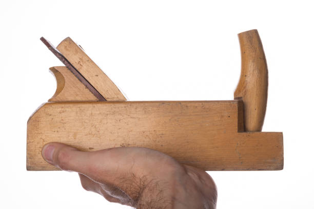 Carpentry planer in hand. Carpenters accessories. Light background.