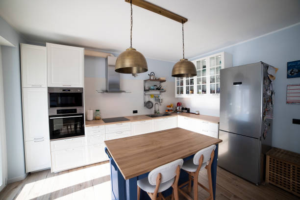 istock White kitchen with blue island and wooden floor. 1216262029