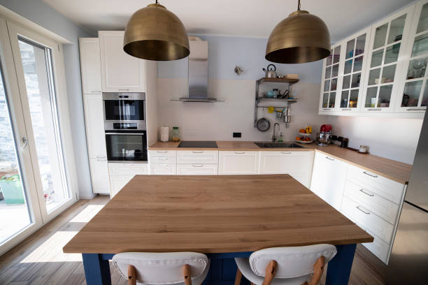 istock White kitchen with blue island and wooden floor. 1216262053