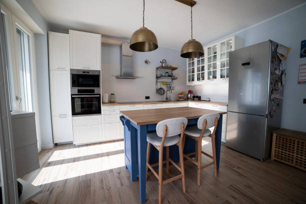 istock White kitchen with blue island and wooden floor. 1216262068