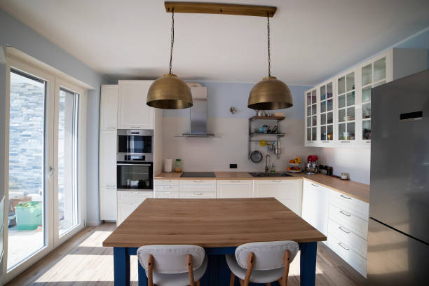 istock White kitchen with blue island and wooden floor. 1216262069