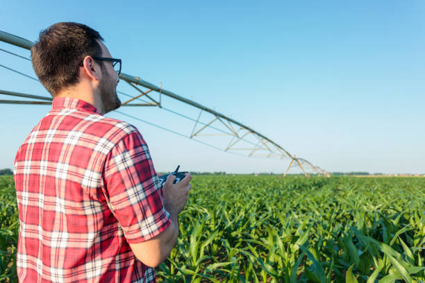 istock Young farmer or agronomist inspecting a corn field using a drone 1216263421