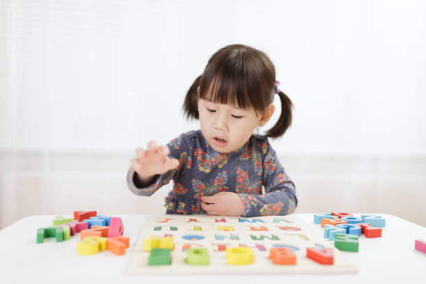 istock toddler girl learning letter blocks for homeschooling 1216267314