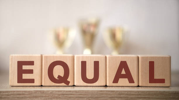 istock TOEIS text on wooden cubes with winning cups 1216268733