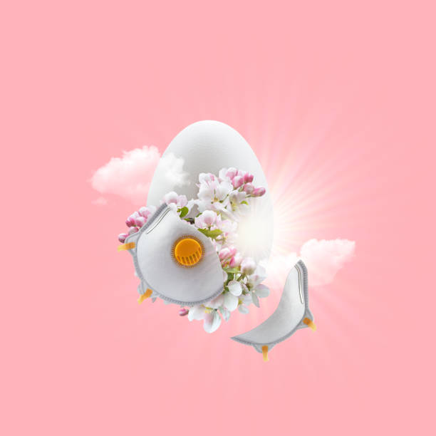istock Easter egg with a sprig of a blossoming apple tree, a broken protective mask and the sun. Easter 2020 concept 1216270991