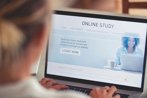 Person working on an online study website. The website has an image of a woman and links to different e-learning education facilities for home schooling