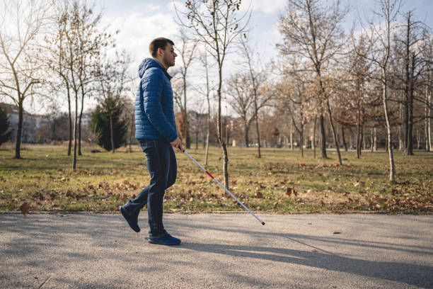 istock Man with a disability enjoying a walk in a public park 1216271473
