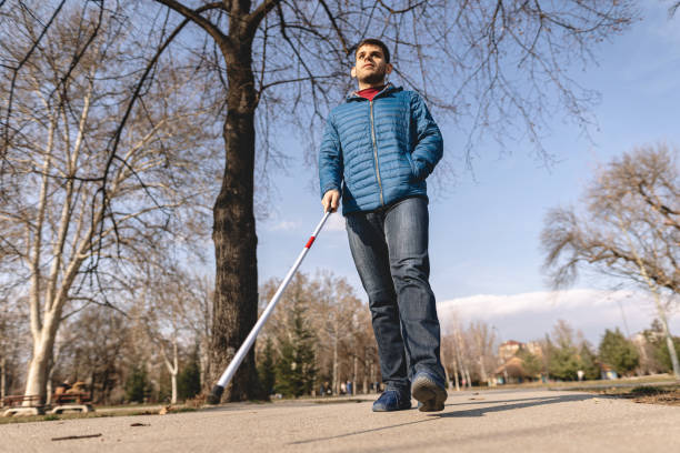 istock Low angle view of a blind man walking outdoors 1216271476