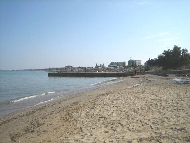istock Sandy beach in quiet Sunny weather. Weak surf caressing the coastal sand. 1216277041