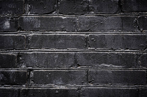 istock Old black painted brick wall texture or background. High contrast and resolution image with place for text. Template for design 1216278352