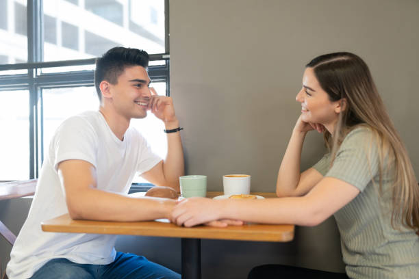 istock Cute couple dating in a restaurant 1216279186