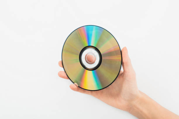 istock partial view of woman holding CD disc on white background 1216279353