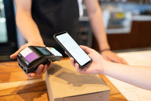 istock Paying with a smartphone at counter 1216279488