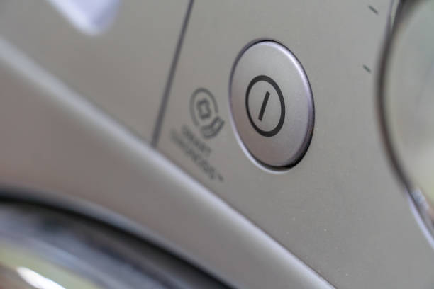 Close-up of the grey washing machine on, off button